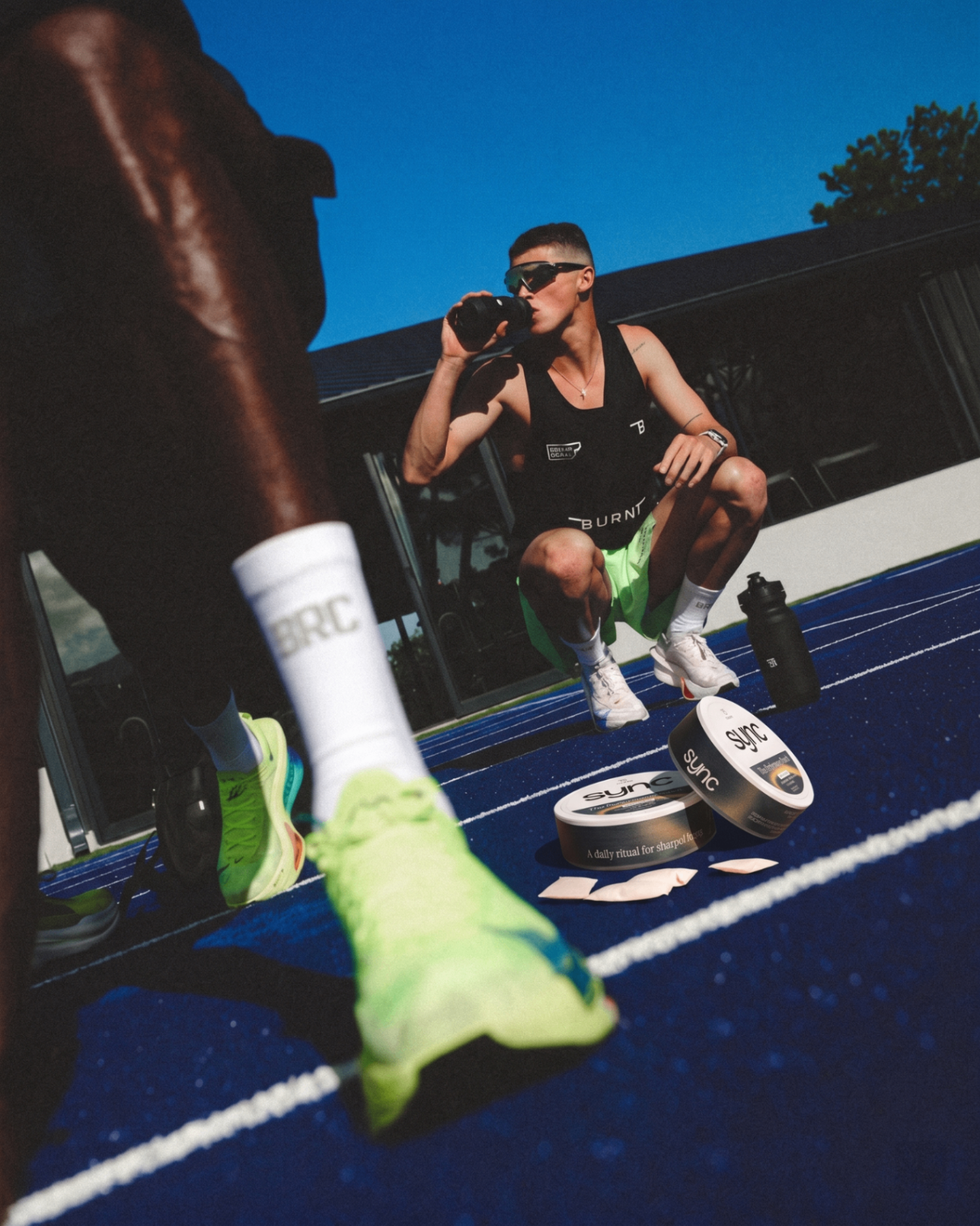 Athlete on a running track with Sync pouches